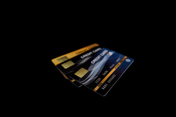 3 blue, black, and yellow credit card images stacked on a black background