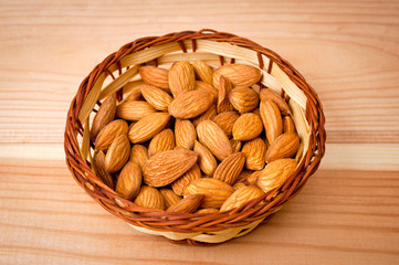 Almonds nuts shot large on a wooden background. Background for healthy eating and vegetarianism.