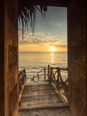 Mooie dor manier naar wit strand met zonsopgang op de achtergrond. Zanzibar