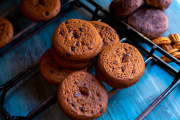 Baked chocolate chip cookies on an artistic background.