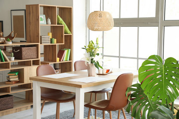 Interior of modern stylish dining room with floral decor