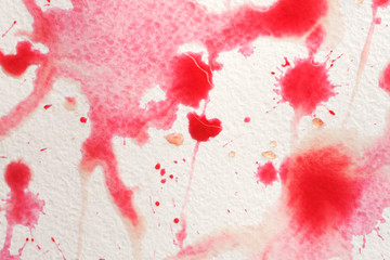 Abstract liquid drops splash fresh pomegranate juice on a white texture paper background for watercolor. Artistic decoration or backdrop. Banner for text, grunge element. Red and pink colors