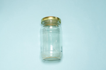 Transparent Glass jar on sky blue background