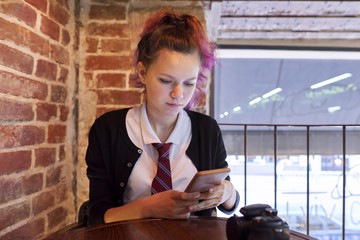 Portrait of teenage girl sitting on chair looking at the camera crane