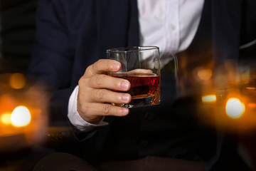 Closeup businessmen holding a glass of whiskey