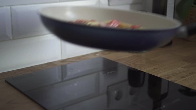 chef frying salmon pasta sause in pan. cooking on oil in kitchen. Spbd cook pour sour cream. concept tomato, roasting, preparation. prepare italian dish on electric stove