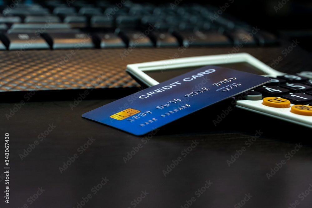 Poster Shallow focus Credit Card on Computer keyboard and calculator. Background for E-commerce and online shopping concept.