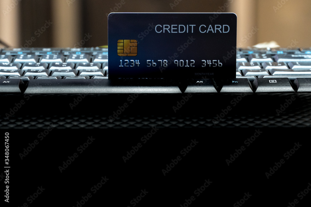 Poster Shallow focus Credit Card on Computer keyboard. Background for E-commerce and online shopping concept.