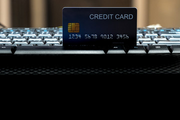 Shallow focus Credit Card on Computer keyboard. Background for E-commerce and online shopping concept.