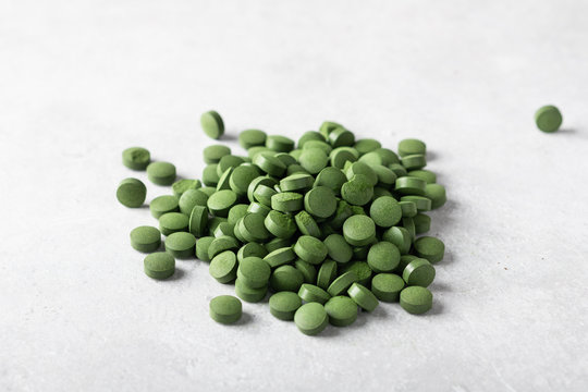 Green chlorella pills. Concept of superfood and detox. 