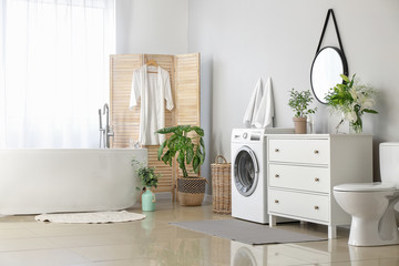 Interior of modern bathroom with floral decor