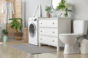 Interior of modern bathroom with floral decor
