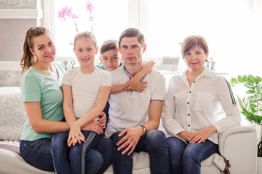 Happy family posing together, smiling and looking at the camera. Horizontal photo