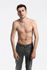 Fototapeta premium Young man with anorexia on color background