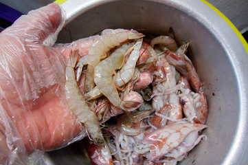 Image of man holding prawns