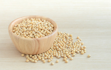Soy bean in wood bowl on wooden table.