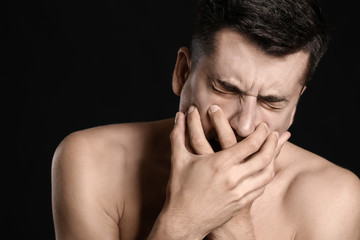Young man with anorexia on dark background