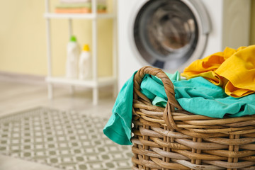Basket with laundry in bathroom
