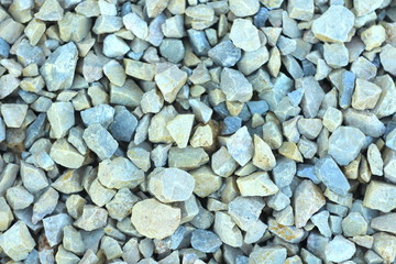 Background of blue and gray gravel. Small stones lie on the ground at a construction site. Pebble pattern on the beach.
