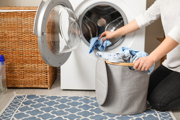 Young woman doing laundry at home