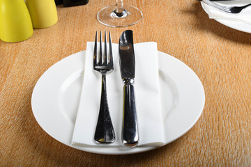 Table setting in an Italian restaurant. Food service for lunch or dinner. No food, fork and knife