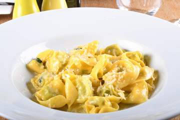 Tortellini with ricotta cheese and spinach, butter, sage sauce, grated parmesan. Parmigiano-Reggiano flakes