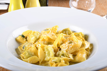 Tortellini with ricotta cheese and spinach, butter, sage sauce, grated parmesan. Parmigiano-Reggiano flakes