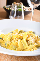 Tortellini with ricotta cheese and spinach, butter, sage sauce, grated parmesan. Parmigiano-Reggiano flakes