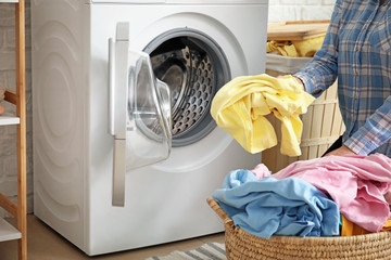 Young woman doing laundry at home