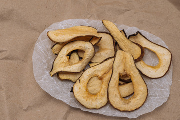 Vegetarian pear chips on craft background