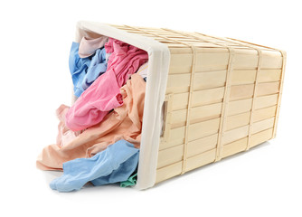 Basket with laundry on white background