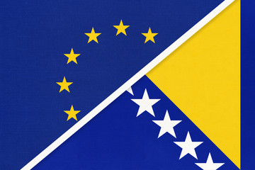 European Union or EU vs Bosnia and Herzegovina national flag from textile. Symbol of the Council of Europe association.