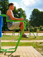 Fototapeta premium Man doing legs exercises in outdoor gym