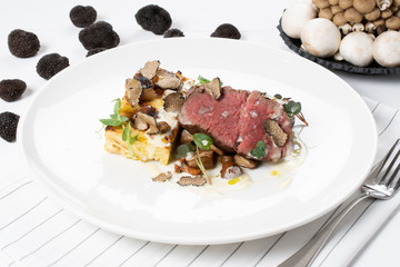 Truffle scented Beef Tenderloin, local truffle, gratin potatoes, sauteed wild mushrooms, cheese sauce