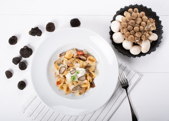 Orecchiette pasta with ceps, cherry tomatoes, ricotta gratin, fresh truffles and wild mushrooms