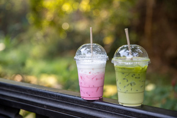 Matcha Milk , Milk Green tea latte and pink milk shake  outdoors on nature  background