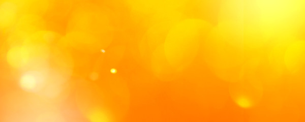 abstract orange background with bokeh lights and sunlight, panoramic background