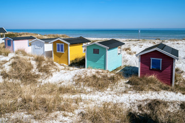 Fototapeta na wymiar Beach huts or bath cottages on Skanor beach dunes and Falsterbo in South Sweden, Skane travel destination. Domestic tourism concept