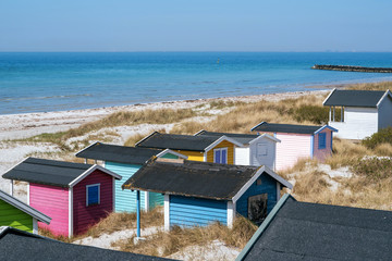 Obraz premium Beach huts or bath cottages on Skanor beach dunes and Falsterbo in South Sweden, Skane travel destination. Domestic tourism concept