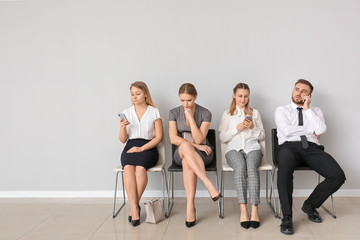 Fototapeta premium Business people waiting in line indoors