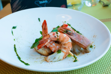 Shrimp, bruschetta with tomatoes, garlic and fresh basil