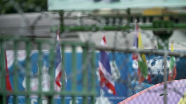 Razor Wire On The Fence at the Thai Burmese Border - Flags Of Thailand Behind - Racking Focus