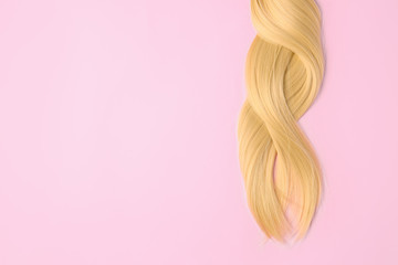 Naklejka premium Beautiful long blonde hair on color background