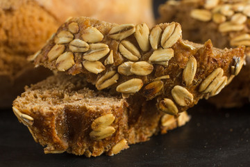 Breaking Bread Homemade bread loaf on rustic dark background