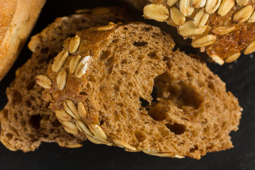 Breaking Bread Homemade bread loaf on rustic dark background