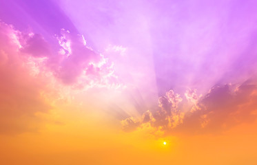 orange sunset light in purple sky with clouds,fantasy sky