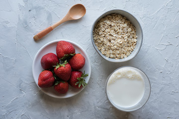 Healthy breakfast: oats, milk, strawberry
