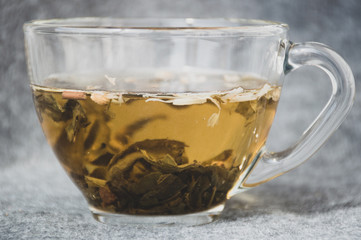 glassy cup with green leaf tea 