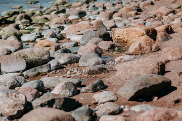Ocean shore, sand and rocks on the sea coast.