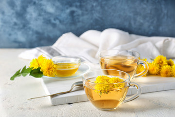 Healthy dandelion tea with honey on table